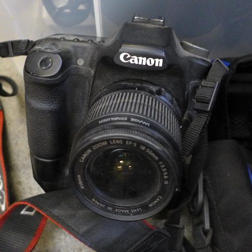 715 - A Canon EOS 40D camera with winder, Canon EOS 1000D camera, a Nikon AF-S Nikkor 55-300mm 1:4.5-1:3.5... 