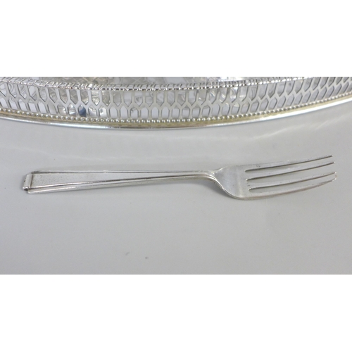 740 - A silver fork, a chased silver plated tray by Viners, a pair of silver plated asparagus tongs and tw... 