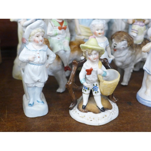 770 - A large collection of English and Continental porcelain and bisque figures, including three children... 