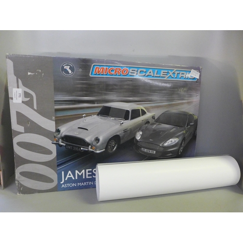 771 - A James Bond Micro Scalextric set, boxed and a James Bond cars poster