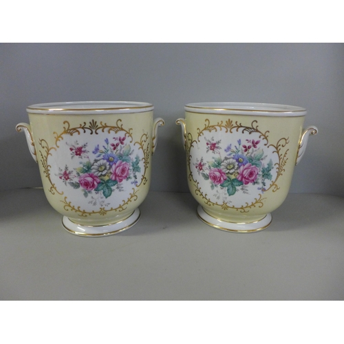 774 - A pair of ceramic planters decorated with a bouquet of flowers