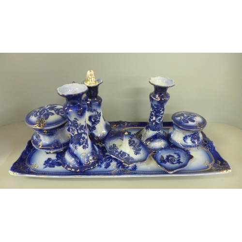 782 - A 19th Century flow blue dressing table set, a pair of candlesticks, a ring stand, two powder pots, ... 