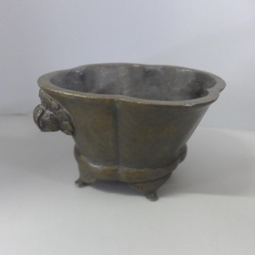 788 - An oriental bronze censer, a brass jardiniere and an ashtray formed from a sword handle