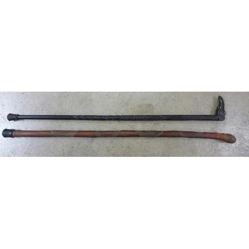 800 - A Japanese carved walking cane and a carved ebony walking stick