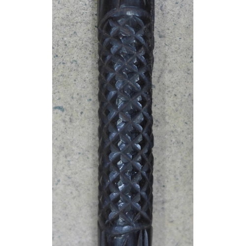 800 - A Japanese carved walking cane and a carved ebony walking stick