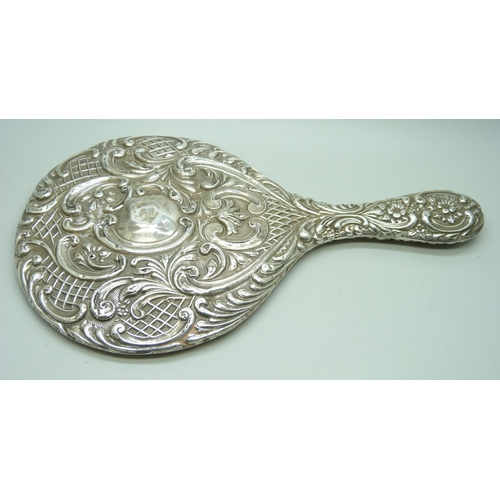 833 - An embossed silver hand mirror, a/f