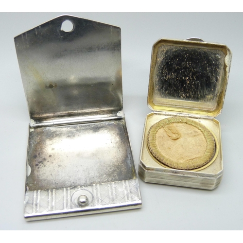 843 - A white metal compact and a white metal match book holder, (both test as silver)