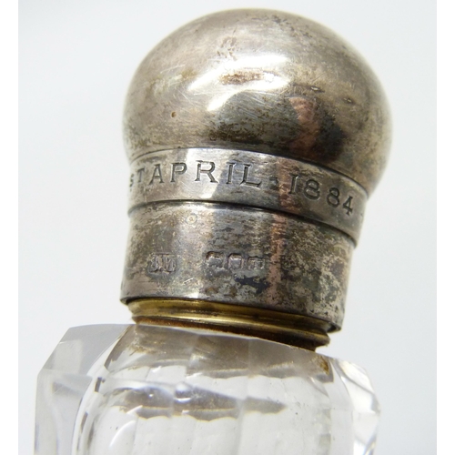 855 - A Victorian silver topped glass scent bottle, bears inscription dated 1884