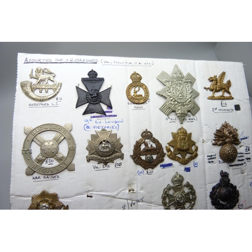 868 - A collection of twenty-two regimental cap badges