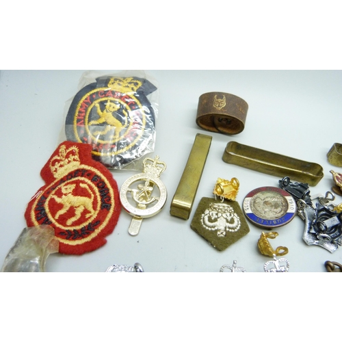 869 - A collection of military badges, dog tags, other badges, etc.