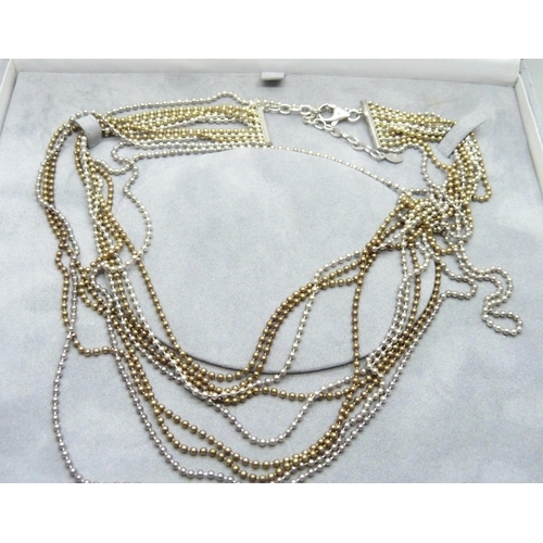 873 - An eleven strand silver and silver gilt necklace, boxed