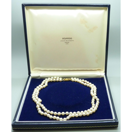 889 - A double row pearl necklace, with hallmarked 9ct gold clasp, boxed