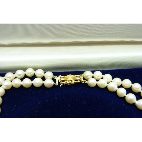 889 - A double row pearl necklace, with hallmarked 9ct gold clasp, boxed