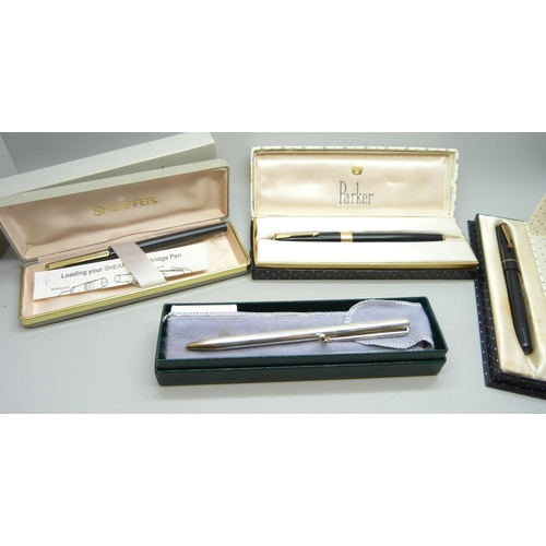 899 - Four pens; a silver New England ballpoint with golf club clip and 14ct gold golf ball detail, boxed,... 