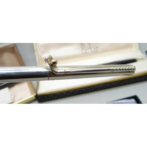 899 - Four pens; a silver New England ballpoint with golf club clip and 14ct gold golf ball detail, boxed,... 