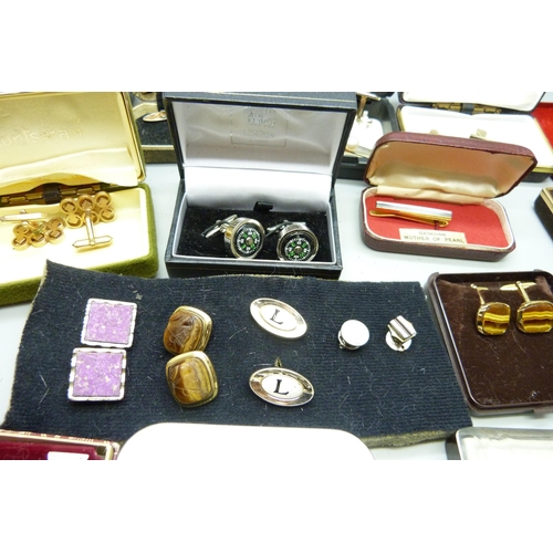 919 - A collection of boxed cufflinks and tie-pins