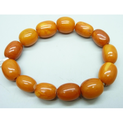 930 - A butterscotch amber bead bracelet, 19.5g