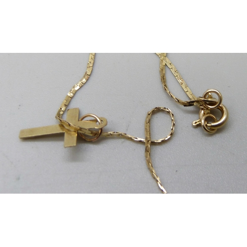 931 - A 14ct gold neck chain with a small cross pendant, 2.4g