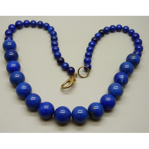 933 - A large and heavy lapis lazuli graduated bead necklace, 204g, 62cm