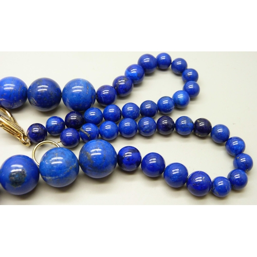 933 - A large and heavy lapis lazuli graduated bead necklace, 204g, 62cm