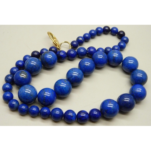 933 - A large and heavy lapis lazuli graduated bead necklace, 204g, 62cm