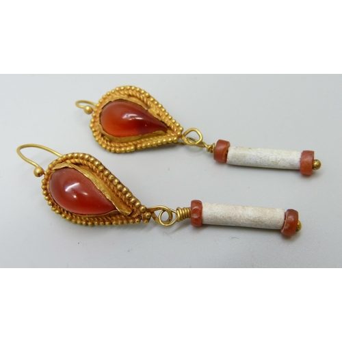 941 - A pair of early Egyptian drop earrings set with orange stone