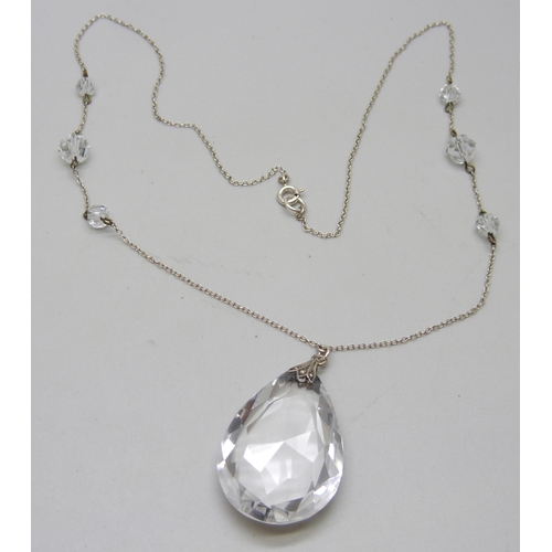 942 - A circa 1930 rock crystal faceted teardrop pendant with fancy spacers on silver chain, 16.9g, 56cm a... 