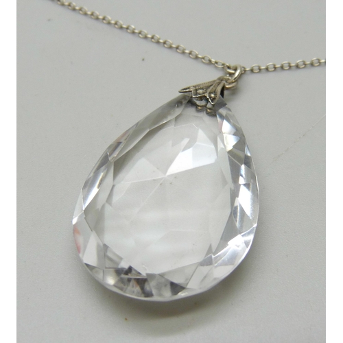 942 - A circa 1930 rock crystal faceted teardrop pendant with fancy spacers on silver chain, 16.9g, 56cm a... 