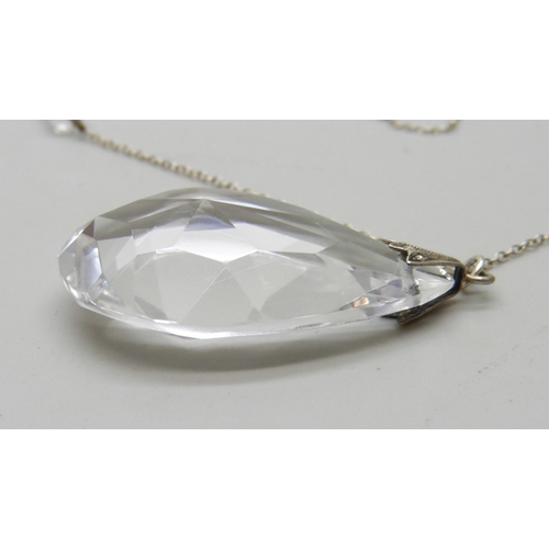 942 - A circa 1930 rock crystal faceted teardrop pendant with fancy spacers on silver chain, 16.9g, 56cm a... 