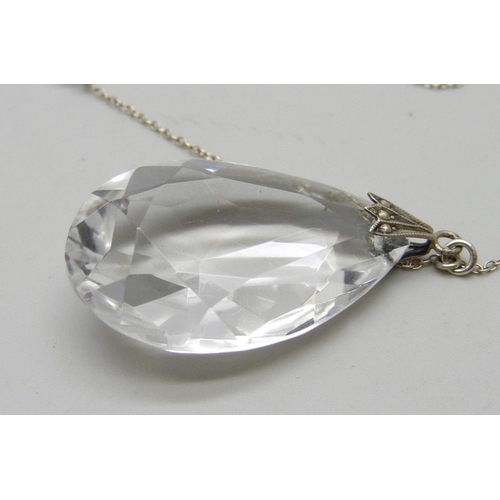 942 - A circa 1930 rock crystal faceted teardrop pendant with fancy spacers on silver chain, 16.9g, 56cm a... 