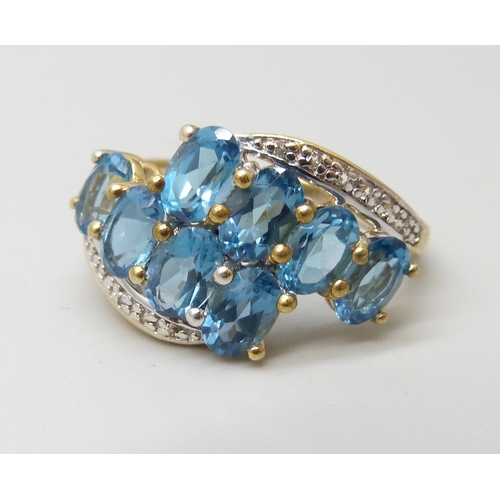 950 - A silver gilt Gemporia blue topaz with diamond accent ring, R/S