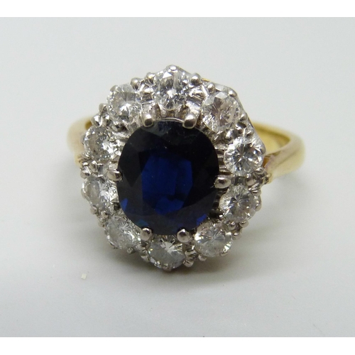 958 - An 18ct gold ten stone diamond and sapphire halo cluster ring, 5.4g, M