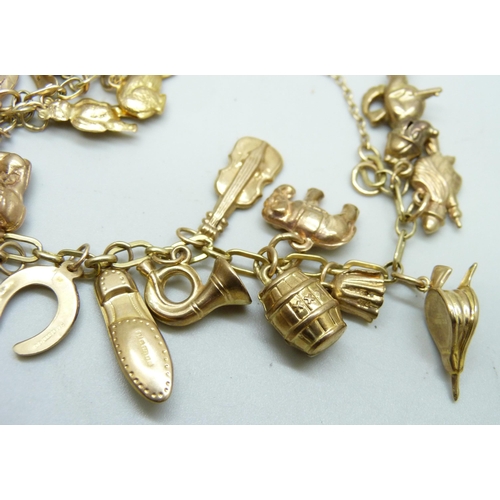 982 - A 9ct gold charm bracelet, 25.2g