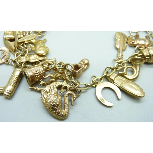 982 - A 9ct gold charm bracelet, 25.2g