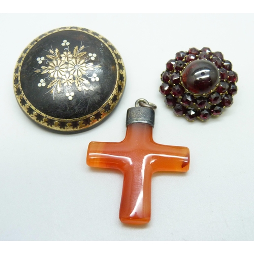 996 - A Bohemian garnet brooch, a tortoiseshell pique brooch and a cross pendant