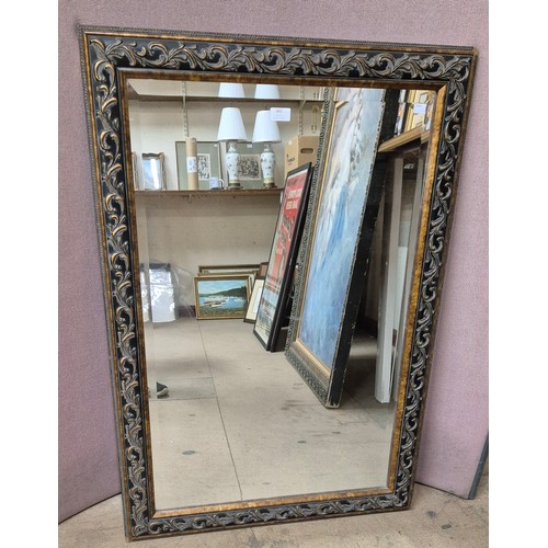 365 - A large ebonised and parcel gilt framed mirror