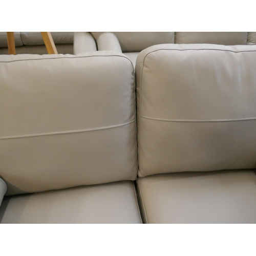 1380 - A stone leather two seater sofa