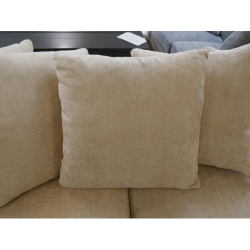 1422 - An oatmeal velvet three seater sofa