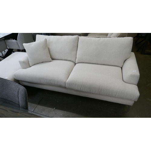 1447 - An oatmeal upholstered three seater sofa