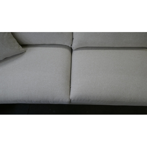 1447 - An oatmeal upholstered three seater sofa