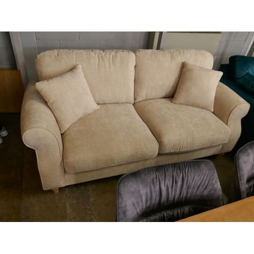 1450 - An oatmeal velvet three seater sofa