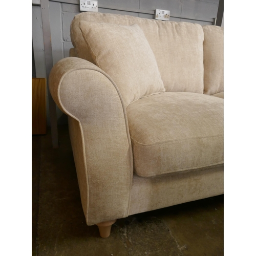 1450 - An oatmeal velvet three seater sofa