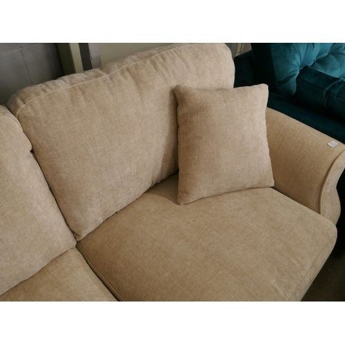 1450 - An oatmeal velvet three seater sofa