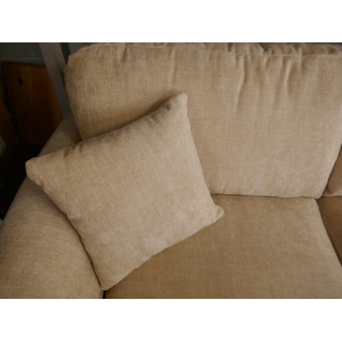 1450 - An oatmeal velvet three seater sofa