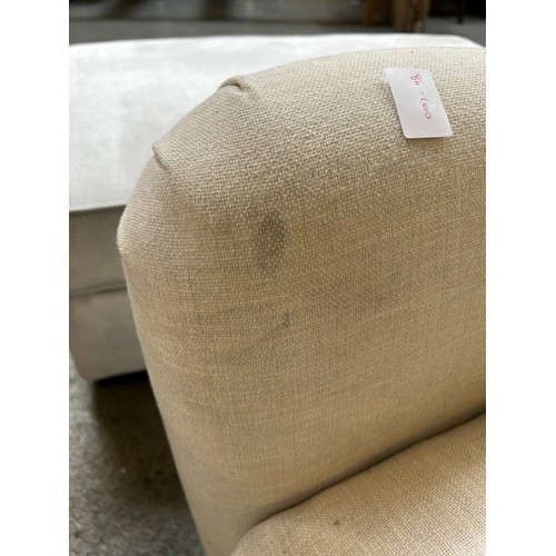 1477 - An off white upholstered three seater sofa