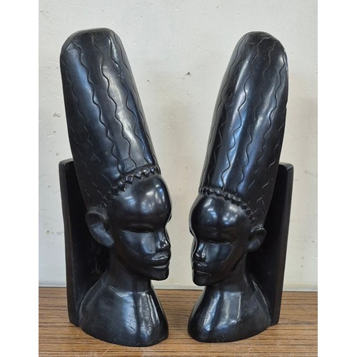 343 - A pair of ebonised carved African bookends