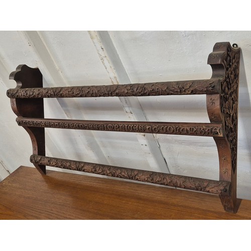 342 - A Black Forest style carved oak wall rack