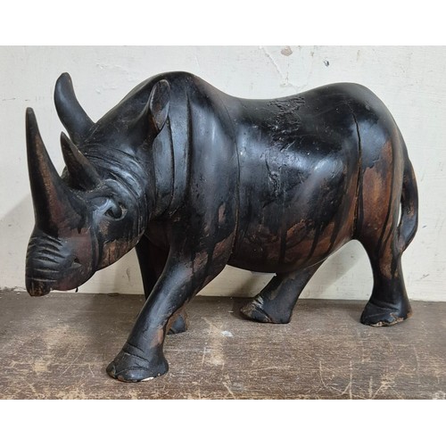 336 - An African carved hardwood figure of a rhinoceros