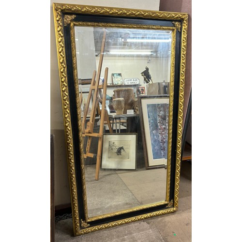 325 - A large Victorian style ebonised and parcel gilt framed mirror