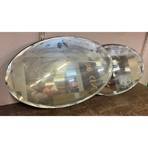 324 - Two oval bevelled edge mirrors